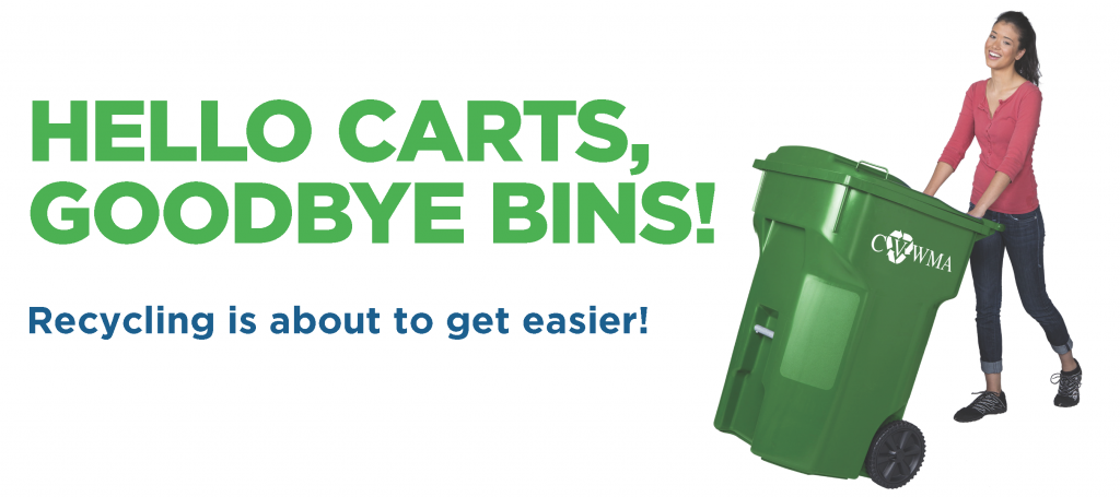 Hello Carts, Goodbye Bins! Recycling is about to get easier. A smiling long-haired person in pink shirt and blue jeans wheels a large green recycling cart with "CVWMA" in white on the side.