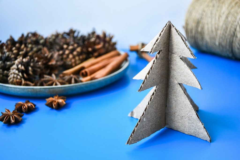 cardboard christmas tree, pinecones and cinnamon sticks