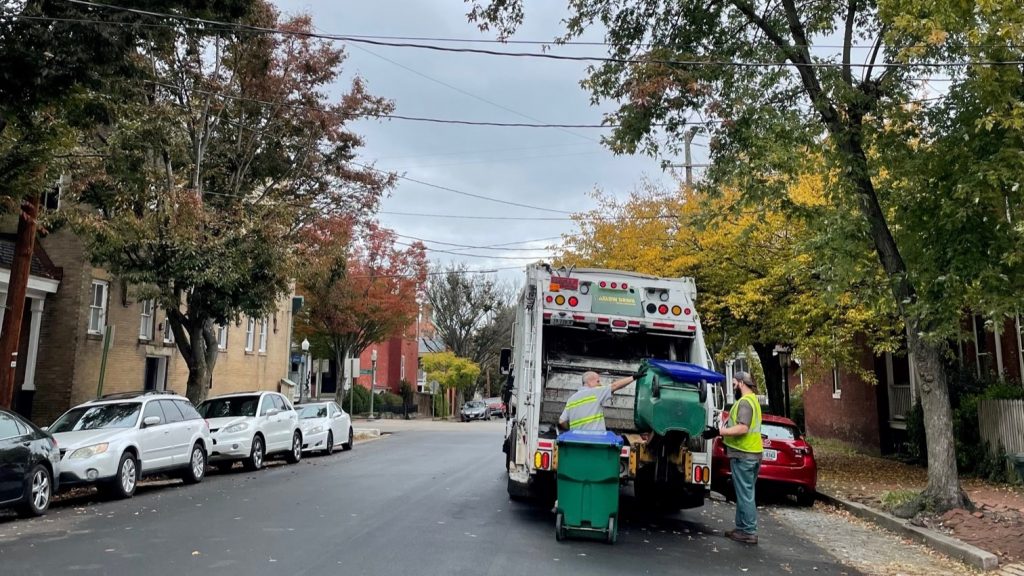 recycling collection crews empty green rolling carts into the back of a truck in richmond's church hill neighborhood